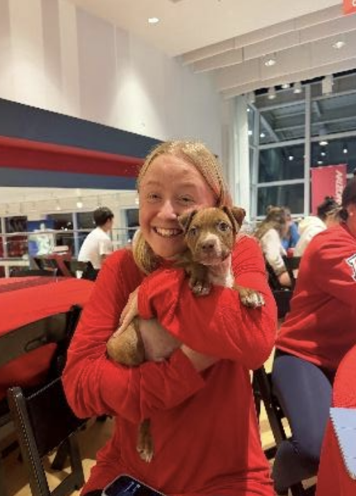 Arizona student-athlete holding a puppy from the Humane Society